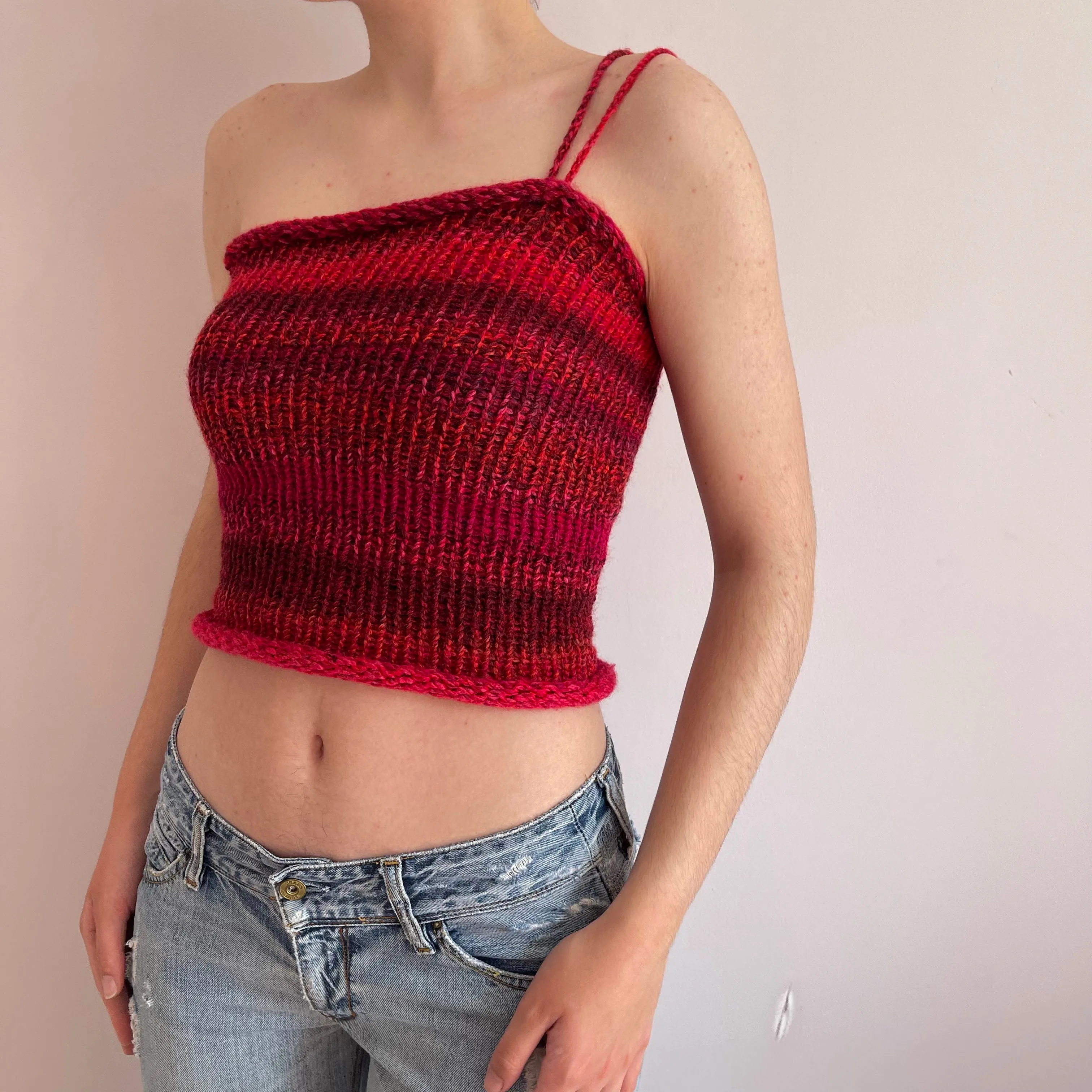 Handmade knitted asymmetrical top in red tones