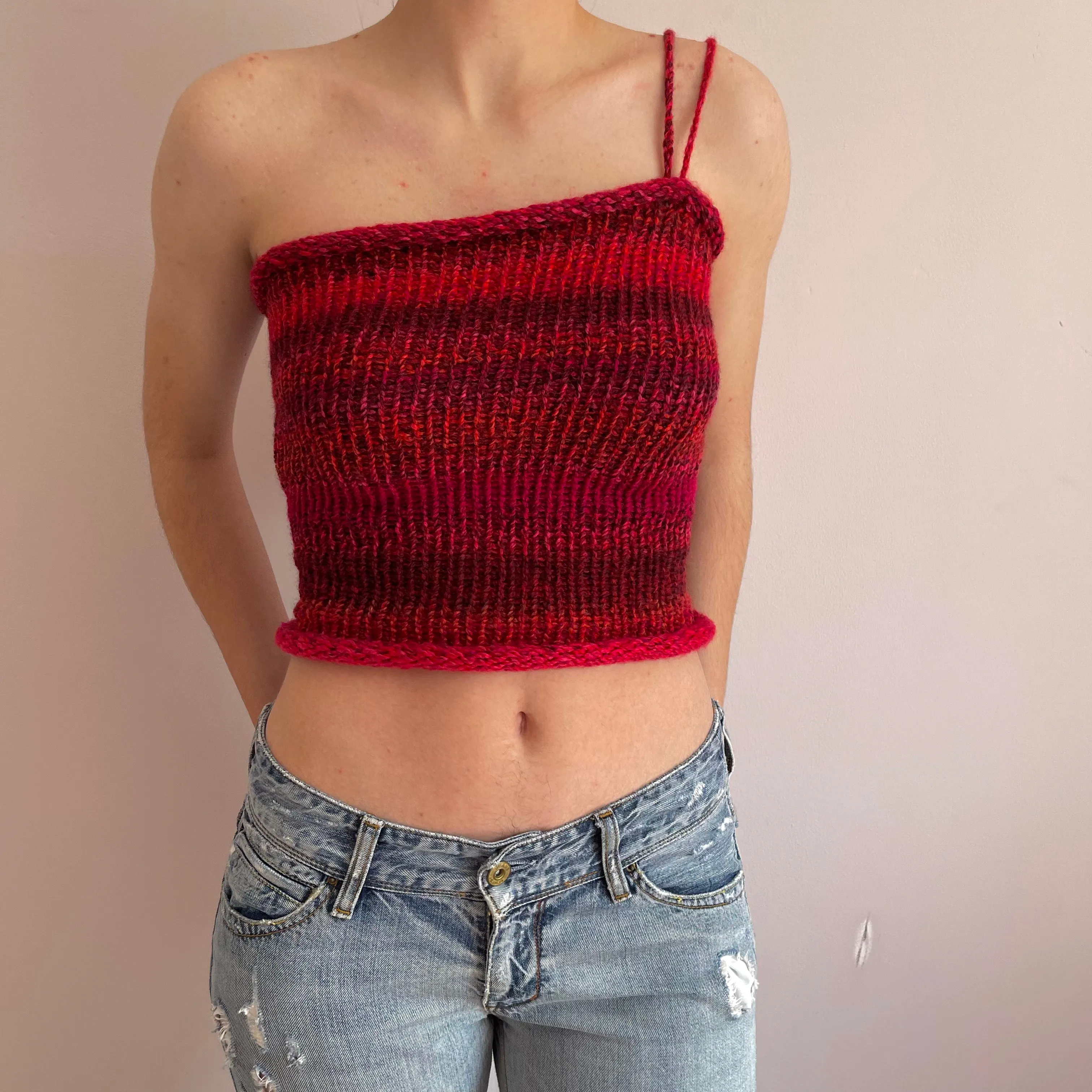 Handmade knitted asymmetrical top in red tones